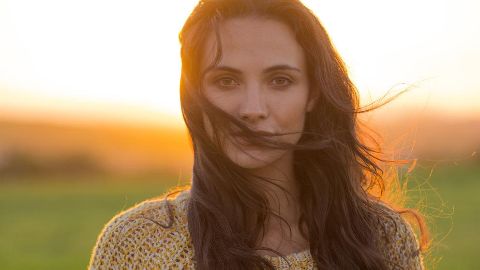 Woman with dark hair in sunset