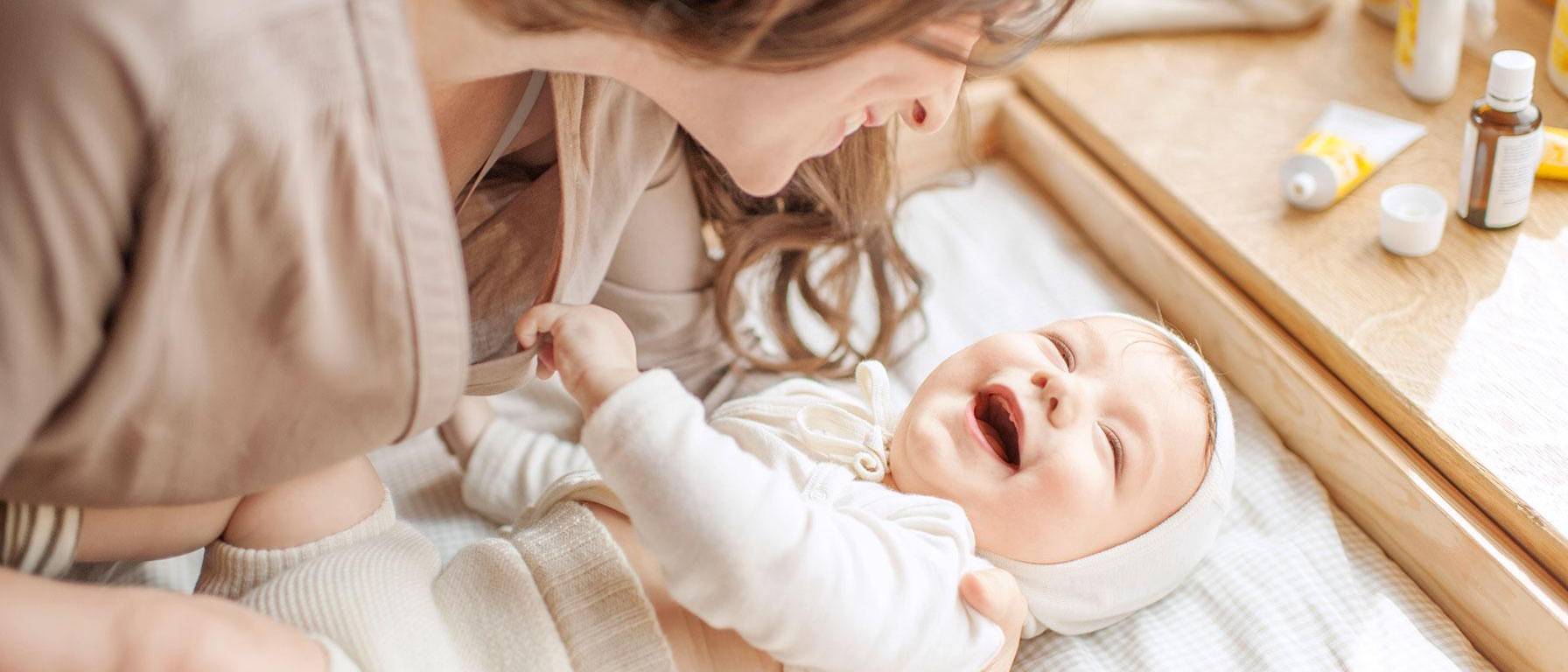 Mommy and baby laugh after massage
