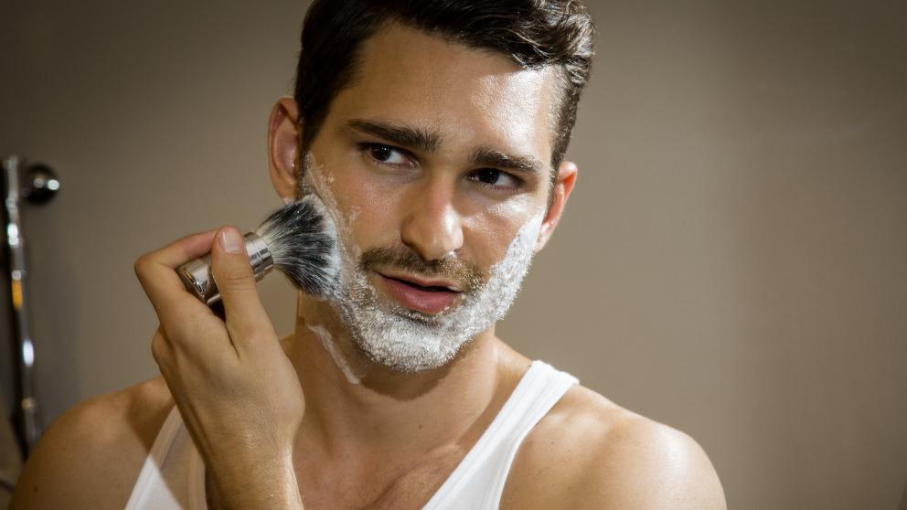 Man applying Weleda Shaving Cream with brush